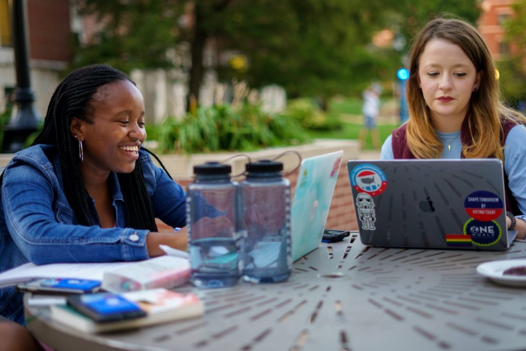 Students outside at table